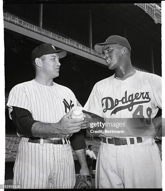 New York Yankees' pitcher Allie Reynolds holds a baseball with Brooklyn Dodgers' pitcher Joe Black during a workout at Yankee Stadium. The pitchers...