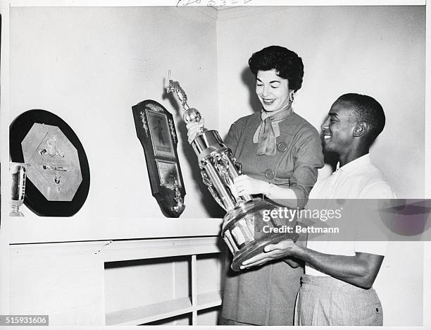 Chicago Cubs shortstop Ernie Banks and his wife, Eloyce, find a spot on the mantle for Banks' second National League Most Valuable Player trophy at...