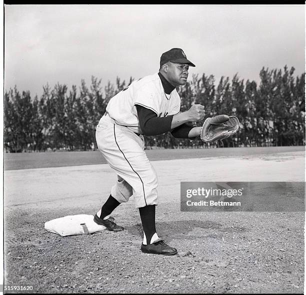 New York Giants third baseman Hank Thompson stands ready to catch the ball.