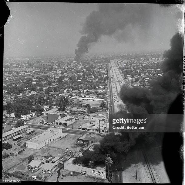 Los Angeles, CA: Smoke darkens the sky over Southwest Los Angeles as fires burn over a wide area along with looting and violence for the fourth day...