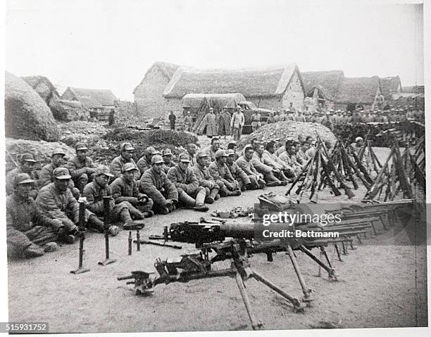 Suchow, China: Chinese Communist soldiers captured on the Suchow front are shown with their captured weapons.