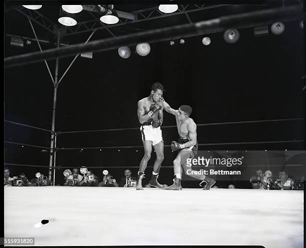 New York, NY: British fighter and erstwhile middleweight champ, Randy Turpin , appears as if he threw this hard right to Sugar Ray's jaw, with all...