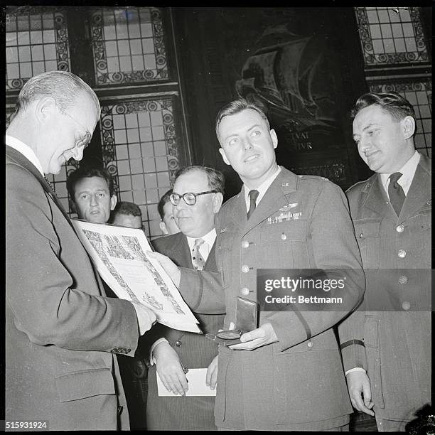 Paris, France: Paris City Council Chairman Jacques Peron awards the scroll and the medal of the city of Paris to distinguished guest Major Arthur...