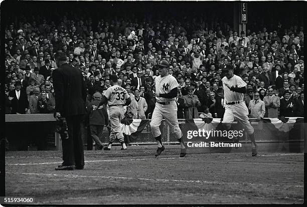New York, NY: Mickey Mantle happily trots home with the winning run of the third World Series game as Cards reliever Barney Schultz exits. Mickey...