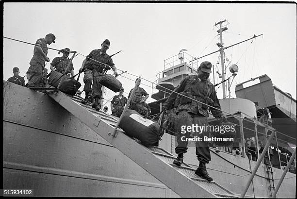 Saigon, Vietnam: Part of more than 2,000 American troops disembark from their boat here. The new troops will be assigned to the first logistical...