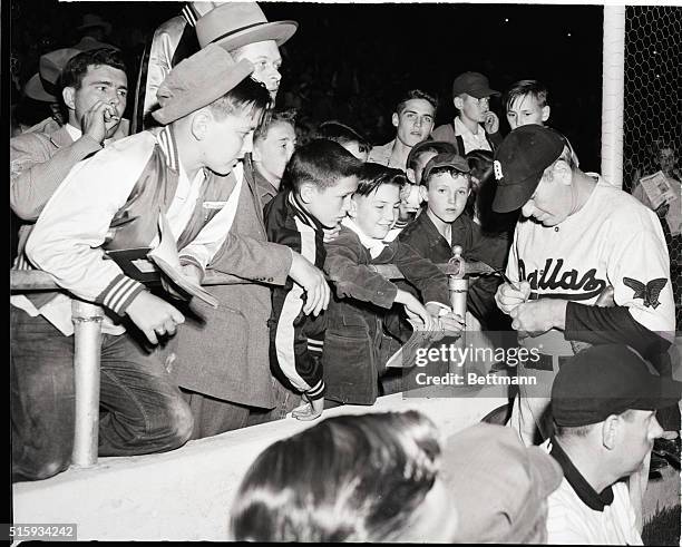 Dallas, TX: Dizzy Dean, former St. Louis Cardinals' pitching ace, signs autographs for youngsters at the opening of Texas League play in the Cotton...