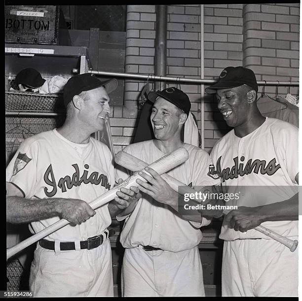 Cleveland, OH: Happy Bob Feller of the Indians thanks teammates Sam Chapman and Luke Easter for their help in packing up the third no-hitter of his...