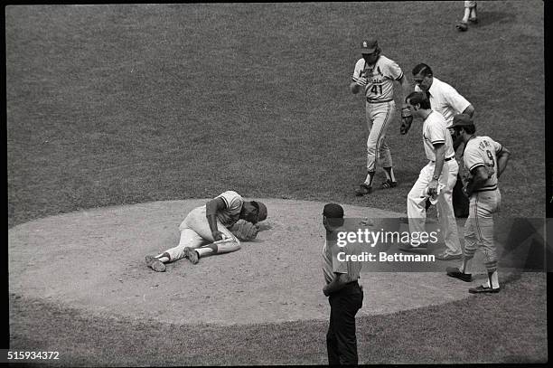 New York, NY: Clutching leg, St. Louis Cardinal ace pitcher Bob Gibson in pain on mound 8/4 at start of fourth inning. Gibson, who had injured leg as...