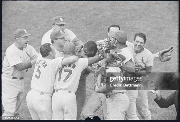 Boston, MA: Cardinals' pitcher Bob Gibson gets mobbed by is teammates after pitching a 3-hit ball game to win the 1967 World Series, beating the Red...