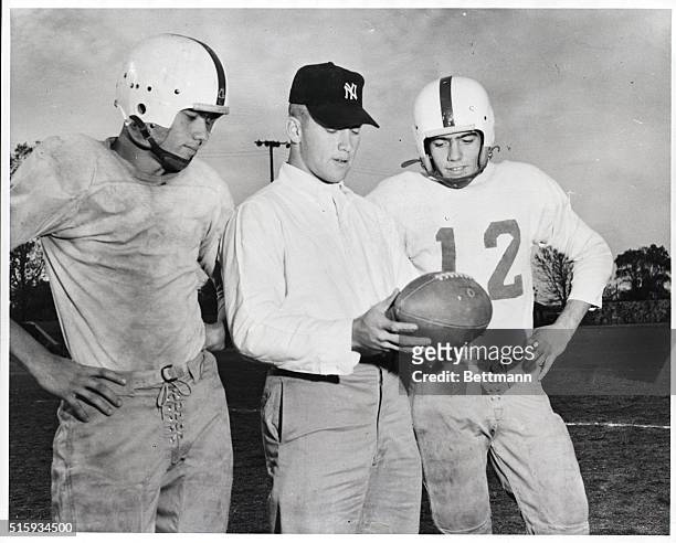 Commerce, OK: Mickey Mantle, flanked by his twin brothers, Roy and Ray, star halfbacks of the Commerce High School Tigers. Picture was taken on the...