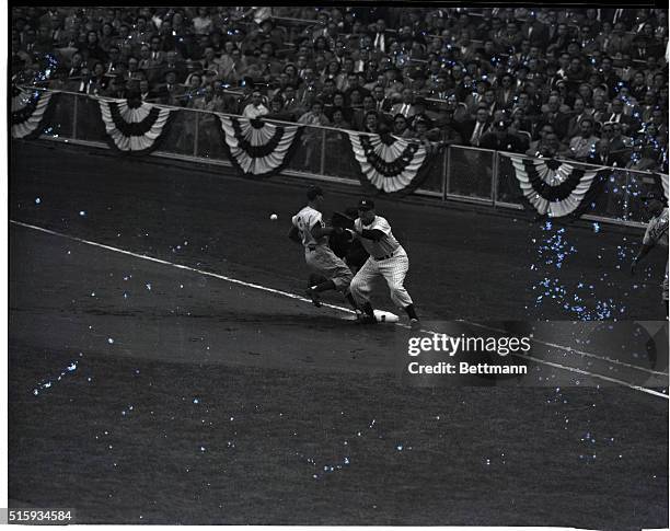 New York: Brooklyn Dodgers' third baseman Billy Cox scoots back to first base, as New York Yankee first baseman Johnny Mize takes the ball from...