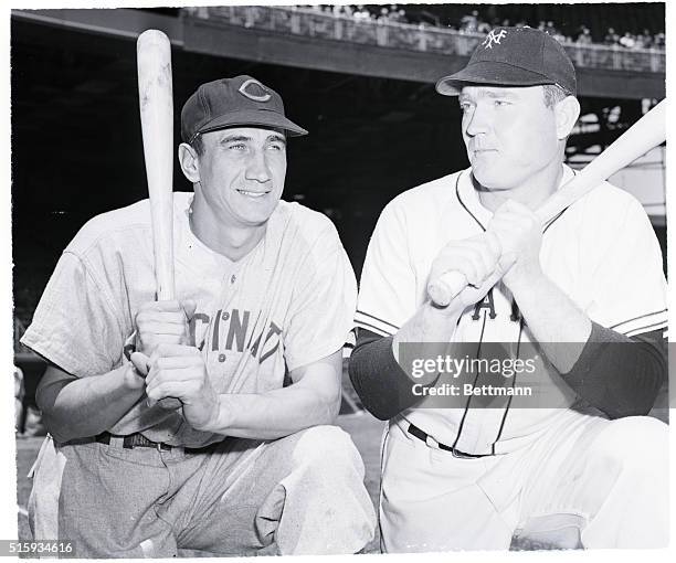 New York, NY: Cincinnati leftfielder Hank Sauer , who has nine home runs to his credit, compares grips with Johnny Mize, of the Giants, who has...