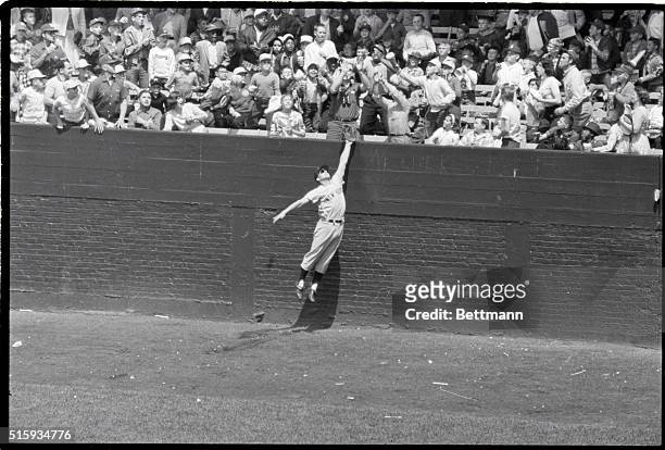 Chicago, IL: New York Yankee rightfielder Roger Maris makes an unsuccessful attempt to snag "White Sox" Jim Rivera's home run into rightfield stands...