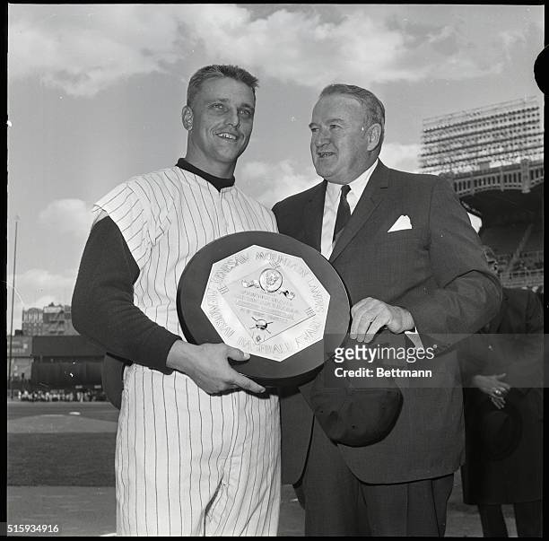 New York, NY: New York Yankee home-run slugger Roger Maris is presented with the American League's Most Valuable Player award by League President Joe...