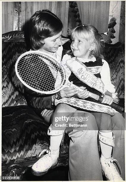 New York, New York- Martina Navratilova, the Women's Tennis Association's Player of the Year, holds March of Dimes poster child, Stacy Strom at the...