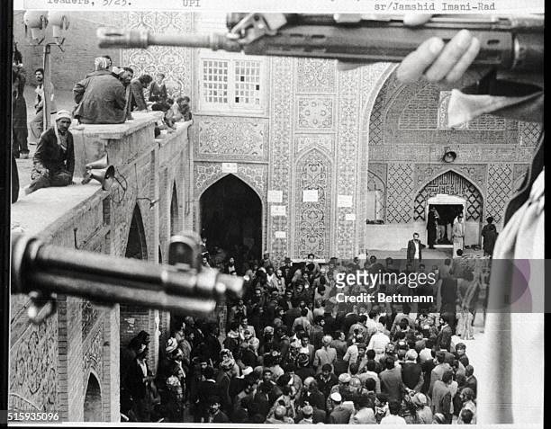 Sanadaj, Iran- Kurdish gunmen stand guard as Ayatollah Mahmoud Taleghani, chief mediator of revolutionary leader Ayatollah Khomeini, walks into the...
