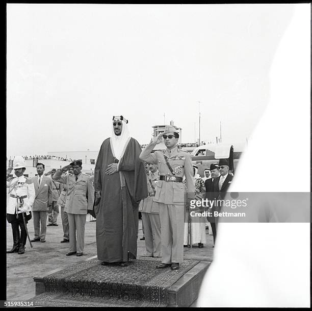 Baghdad, Iraq- King Saud of Saudi Arabia and King Faisal of Iraq take the salute during a welcoming ceremony upon the former's arrival. The historic...