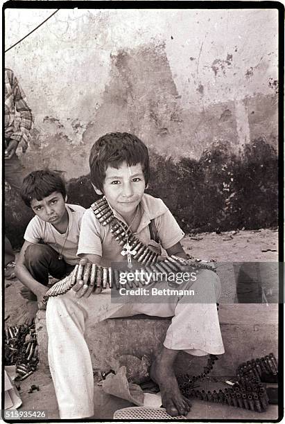 Tejutepeque, El Salvador-A little boy plays with used cartridges in the town of Tejutepeque in Cabanas province, which was taken by leftist...