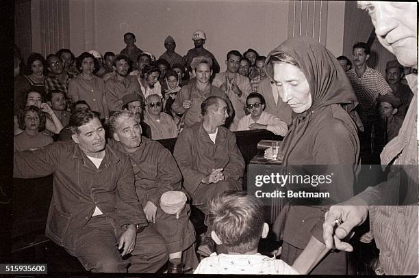 Havana, Cuba-Mrs. Lila Garcia leads one of her two children to the prisoner's bench after accusing former Batista Army Major Jesus Sosa Blanco of...