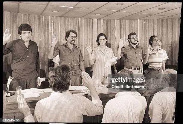 Managua, Nicaragua-The 5-member Nicaraguan junta raise their right hands as they swear in members of their new cabinet for administrating the country...