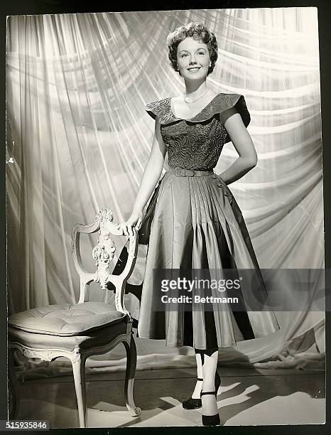 Hollywood, CA- A date dress of iridescent taffeta in neptune green is worn by Virginia Gibson, who is featured in the new comedy-romance, "Stop,...