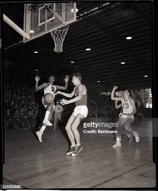 Melbourne, Australia- K.C. Jones of San Francisco, California, and Russia's Mikhail Semenov chase a loose ball in the semifinal Olympic basketball...
