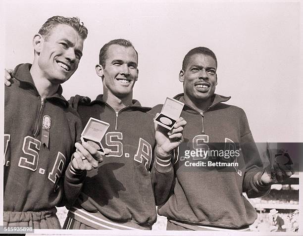 Melbourne, Australia- After the all-American victory in the final of the 200 meter, the winners display their prospective medals. Left to right:...
