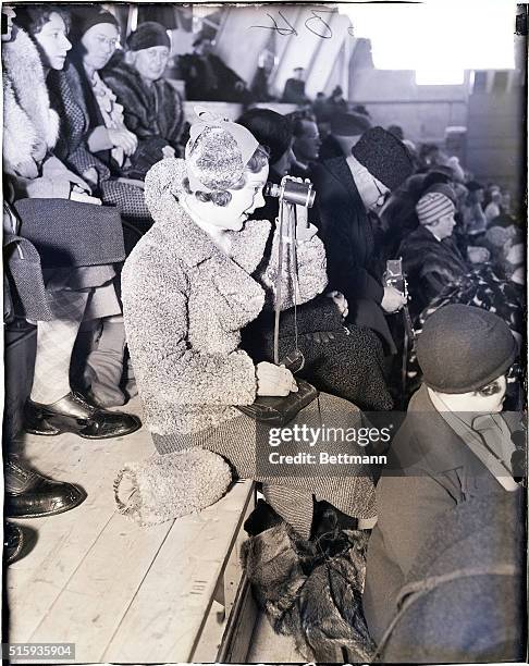 Los Angeles, CA- SONJA HENIE IN GRANDSTAND- A HYPER-CRITICAL AUDIENCE. It must be pretty good figure skating in the part of the men, to make Sonka...
