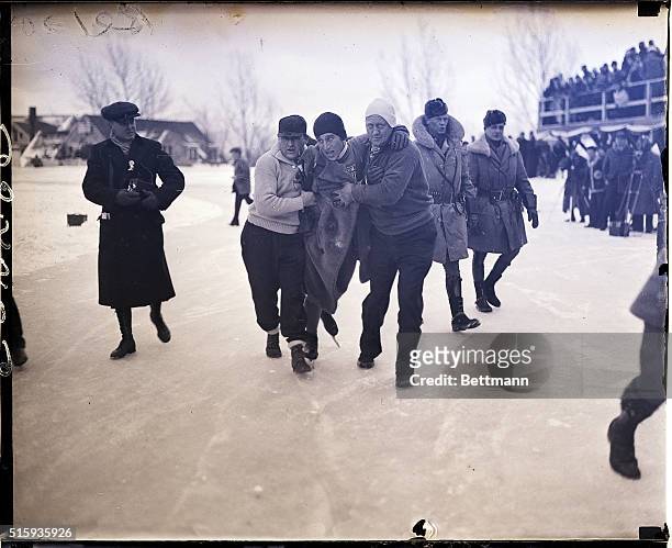 Lake Placid, NY- JAFFEE, WINNER OF OLYMPIC RACE AIDED OFF ICE AT FINISH. Several of his teammates are shown helping Irving Jaffee of the U.S.A....