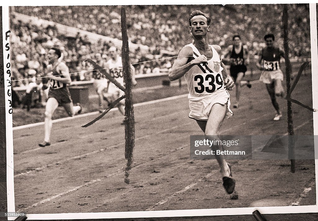 Hurdler Roy Cochran Crossing Finish Line in Olympics