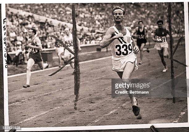 Wembley, England- COCHRAN-AN OLYMPIC CHAMP IN TOP FORM. Roy B. Cochran, west coast hurdling star, is shown as he crossed the finish line in...