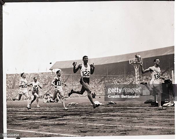 London, England- Mal Whitfield, sensational American middle distance runner is shown as he crossed the finish line in the final of 800 meter Olympic...