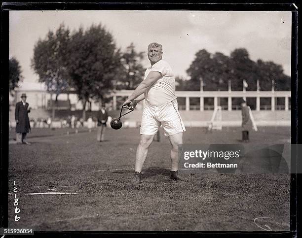 Antwerp, Belgium- Picture shows Pat Mcdonald, of the US, throwing a 56lb. Hammer weight in competition.