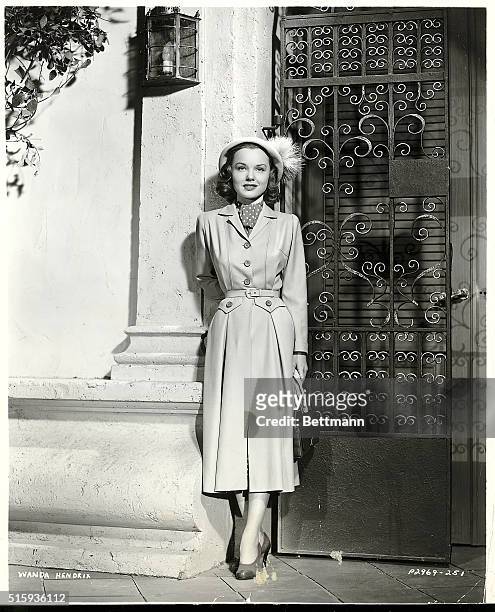 Los Angeles, CA- Wanda Hendrix, Paramount player, appears in a stunning cocoa tan wool coat in scenes from, "Miss Tatlock's Millions". The ensemble...