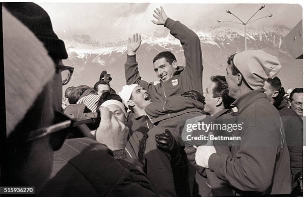 Innsbruck, Austria- A jubilant crowd hoists happy speed skater Terry McDermott of Essexville, Michigan after he won the first gold medal for the U.S....