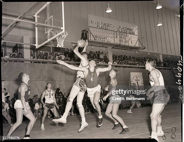 Helsinki, Finland- America wins basketball today when they beat the U.S.S.R. Team. Photo shows incident around the American basket ,Robert Albert...