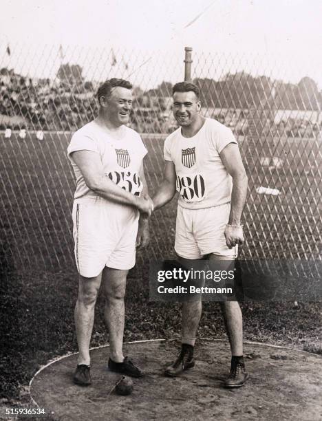 Paris, France- Matt Mac Grath poses with Fred Tootell, winner of the hammer throw, at Colombes Stadium.