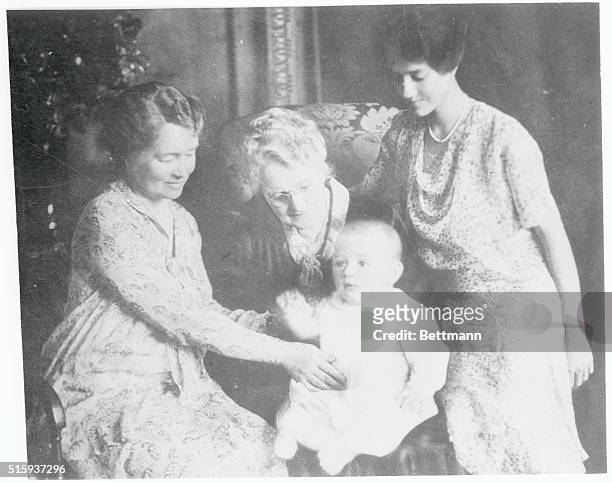 Charles A. Lindbergh, Jr., son of the flier, is shown with his mother, grandmother and great-grandmother. Young Lindy is just seven months old. Right...
