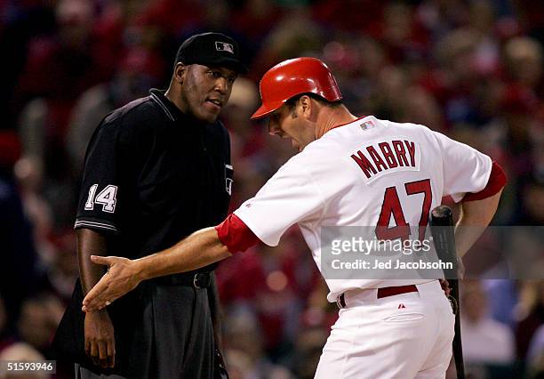 John Mabry of the St. Louis Cardinals argues with home plate umpire Chuck Meriwether after being called out on strikes during game four of the World...