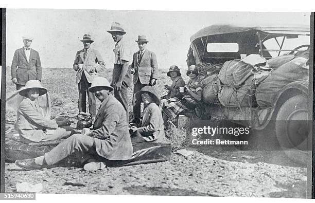 Pictured is a photo taken by British consul General of Ispaham, Mr. Ernest Bustow, showing a group of hardy desert travellers having lunch, about 150...