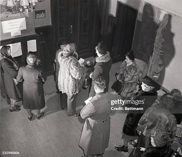 Clutching photographs of missing persons, relitives wait to register the names with the new group. They disappeared in Russian occupied Germany...