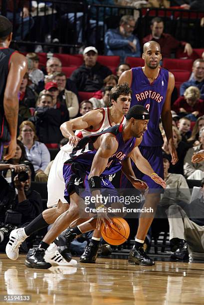 Chris Bosh of the Toronto Raptors takes the ball past Richie Frahm of the Portland Trail Blazers in NBA preseason action October 27, 2004 at the Rose...
