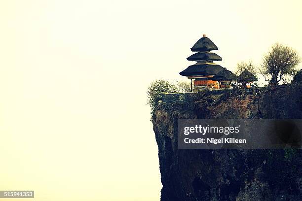 uluwatu temple at sunset - uluwatu stock pictures, royalty-free photos & images