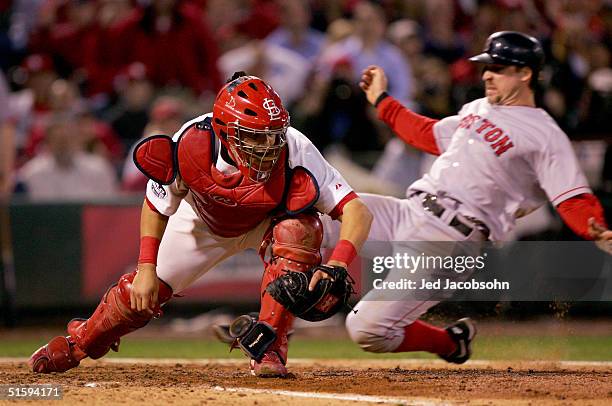 Bill Mueller of the Boston Red Sox is out at home plate by Yadier Molina of the St. Louis Cardinals during the eighth inning of game four of the...
