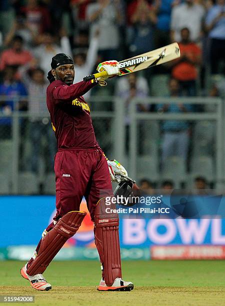 Chris Gayle of the West Indies gestures towards the dressing room as he celebrates his century during the ICC World Twenty20 India 2016 match between...