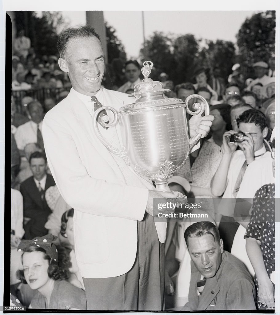 Denny Shute Holding Golf Trophy