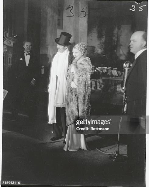 Attired in faultless evening clothes, Edmund Lowe and his wife, Lilyan Tashman, arrive at Grauman's Chinese Theater in Los Angeles for the premiere...