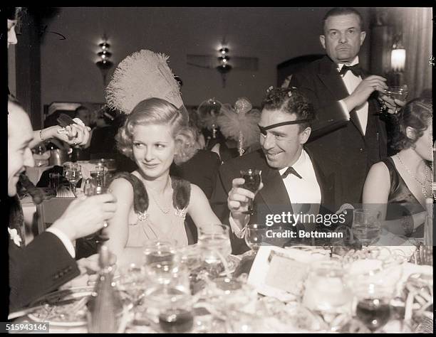 Agua Caliente, Mexico- Joan Bennett, screen star, and Raoul Walsh, director; make whoopee at their table in the Agua Caliente Hotel in Agua Caliente,...