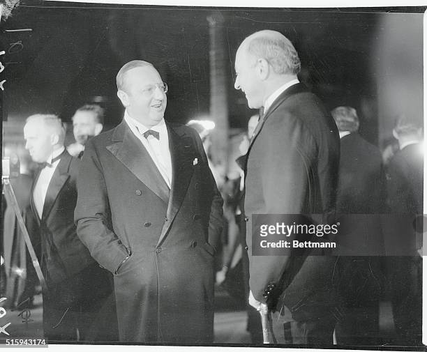 Jesse Lasky and Cecil Demille, Motion Picture Heads, chat in the lobby of Grauman's Chinese Theatre in Los Angeles before the premiere of Cavalcade.