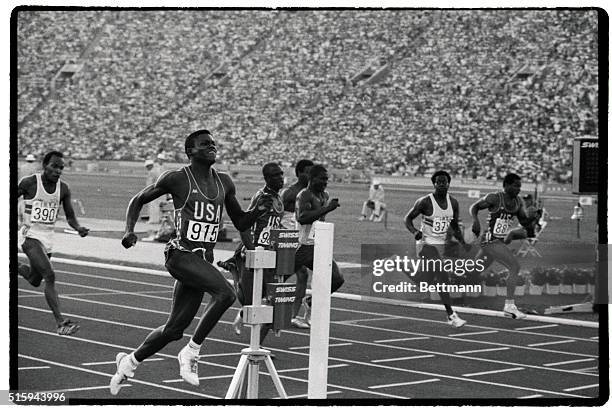 American Carl Lewis crosses the finish line to win the gold medal in the 100-meter dash at the 1984 Summer Olympics in Los Angeles. Lewis'...